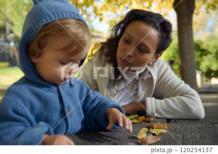 Mother and child bonding during an autumn day in the park 120254137