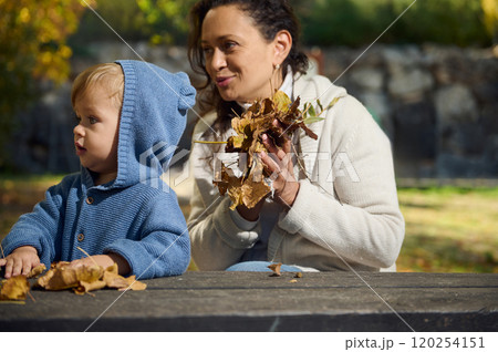 Mother and child enjoy autumn afternoon outdoors together 120254151