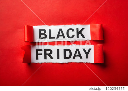 BLACK FRIDAY SALE words on white torn paper on a red background. Sale in November. 120254355