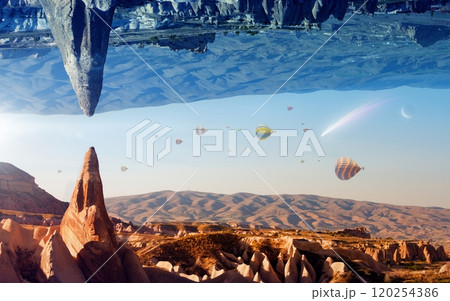 Fantastic unreal turned upside down landscape. Hot air balloons fly in clear morning sky in Cappadocia, Turkey. 120254386