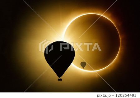 Silhouettes of hot air balloons on backgound of solar eclipse in dark red sky 120254493
