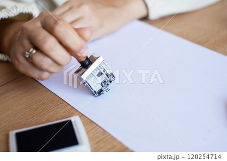 Hand Stamping Document on Desk: Legal, Approval, Office Setting Hand Stamping Document on Desk: Legal, Approval, Office Setting 120254714