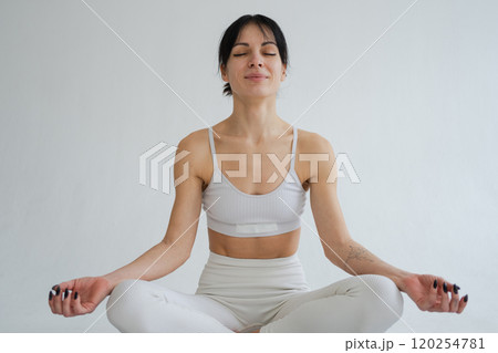 Yoga mindfulness meditation. Healthy woman practicing yoga isolated on white background. Woman sitting in lotus pose meditating relaxing. Girl doing breathing practice. Yoga on white background 120254781