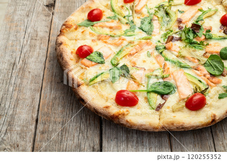 Italian pizza with avocado salmon tomatoes and mozzarella photography. top view Italian pizza with avocado salmon tomatoes and mozzarella photography. top view 120255352