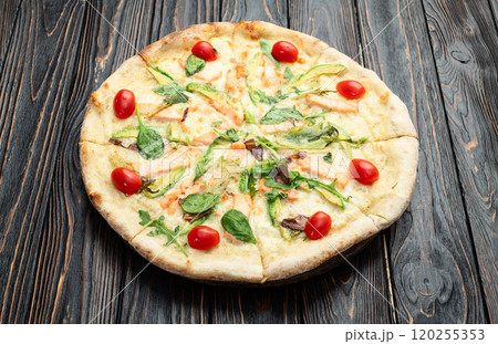 Italian pizza with avocado salmon tomatoes and mozzarella photography. top view Italian pizza with avocado salmon tomatoes and mozzarella photography. top view 120255353