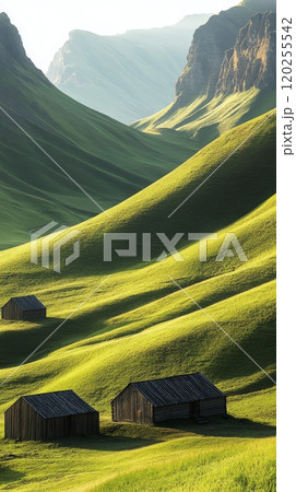 Lush green valley with traditional huts nestled among hills during morning mist 120255542