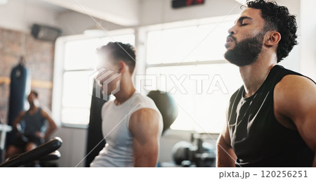Exercise bike, fitness and tired with men in gym together for break from cardio training or workout. Breathing, elliptical machine and sweating with sporty friends in health club for workout together 120256251