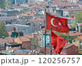 Turkish flags wave in wind above residential neighborhood in Istanbul, Turkey 120256757