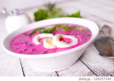 Cold beetroot soup in bowl on wooden background Cold beetroot soup in bowl on wooden background 120257194