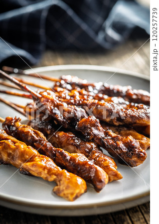 Japanese chicken yakitori on plate on wooden table. Japanese chicken yakitori on plate on wooden table. 120257739