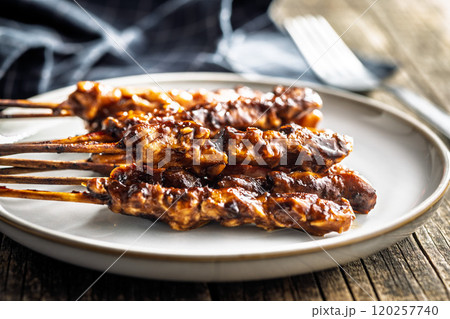 Japanese chicken yakitori on plate on wooden table. Japanese chicken yakitori on plate on wooden table. 120257740
