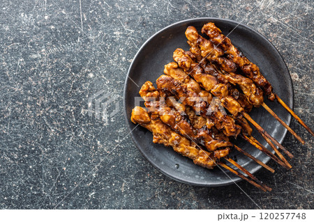 Japanese chicken yakitori on plate on black table. Top view. 120257748