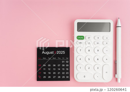 Top view of August 2025 calendar and white calculator with pen on pink background. 120260641