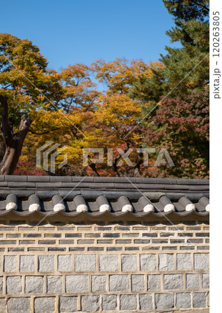Korean traditional stone wall in Changdeokgung palace with beautiful autumn foliage. Korean traditional stone wall in Changdeokgung palace with beautiful autumn foliage. 120263805