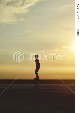 Silhouette young in rollerblading, summer sunset background. Culture Enjoy Sports Vacation 120264375