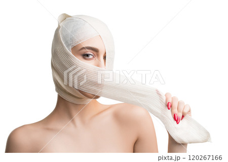 Girl her head and neck bandaged at plastic surgeon 120267166