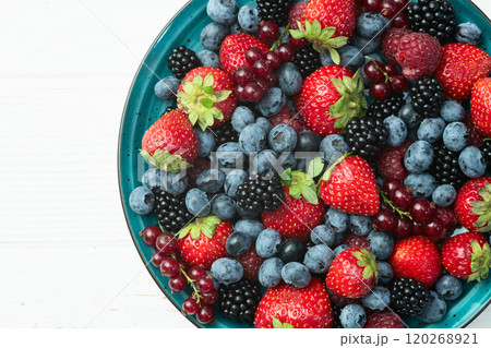 Mix of ripe colorful berries in bowl photography . Blueberry , strawberry , raspberry , blackberry and red currant . Top view Mix of ripe colorful berries in bowl photography . Blueberry , strawberry , raspberry , blackberry and red currant . Top view 120268921