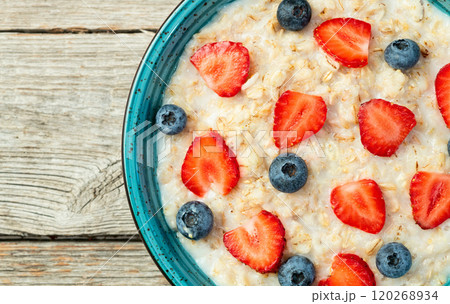 Homemade breakfast . Oatmeal with milk and berries . Top view 120268934