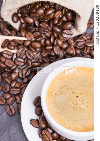 Coffee in white cup and roasted dark coffee beans Coffee in white cup and roasted dark coffee beans 120269189