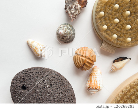 Natural bath essentials with sea shells and exfoliating tools on white background Natural bath essentials with sea shells and exfoliating tools on white background 120269283