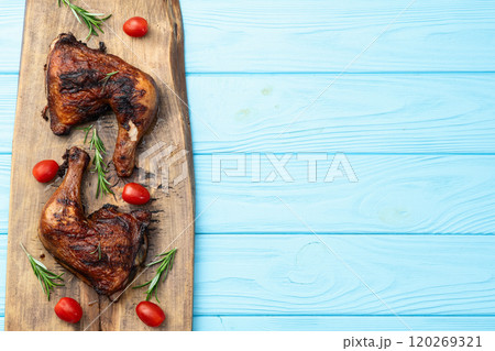 Grilled chicken legs with tomatoes and salad . Top view Grilled chicken legs with tomatoes and salad . Top view 120269321