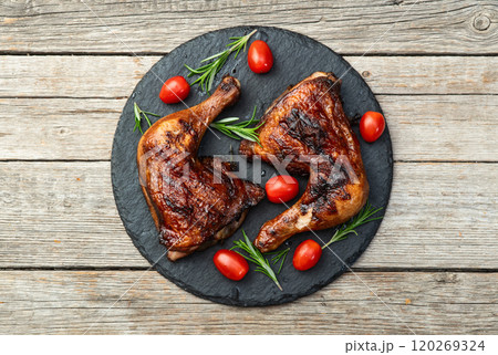 Grilled chicken legs with tomatoes and salad . Top view Grilled chicken legs with tomatoes and salad . Top view 120269324