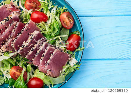 Salad with raw tuna , sesame and cherry tomatoes photography . Top view 120269559