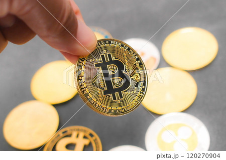 Hand holding bitcoin coin or digital currency 120270904