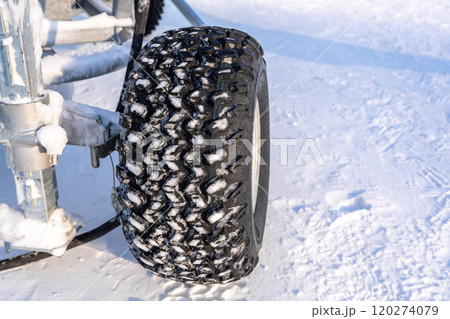 The close up of Winter tyre in the snow field The close up of Winter tyre in the snow field 120274079