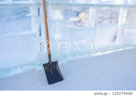 The steel shovel standing against ice wall 120274080