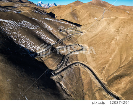 Scenic view of the winding hill road named Pan Long Ancient Road in Tashkurgan, Xinjiang, China. Scenic view of the winding hill road named Pan Long Ancient Road in Tashkurgan, Xinjiang, China. 120274294