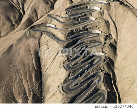 Scenic view of the winding hill road named Pan Long Ancient Road in Tashkurgan, Xinjiang, China. 120274346