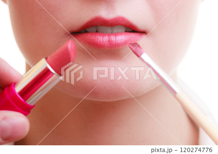 Part of face. Woman applying red lipstick with brush Part of face. Woman applying red lipstick with brush 120274776