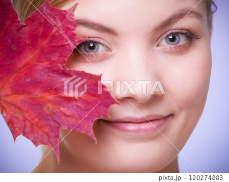 Skin care. Portrait of young woman girl with red maple leaf. Skin care. Portrait of young woman girl with red maple leaf. 120274883