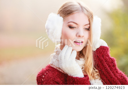 Pretty gorgeous woman in earmuffs. 120274923