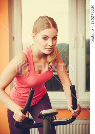 Human working out on exercise bike. Fitness. 120275236