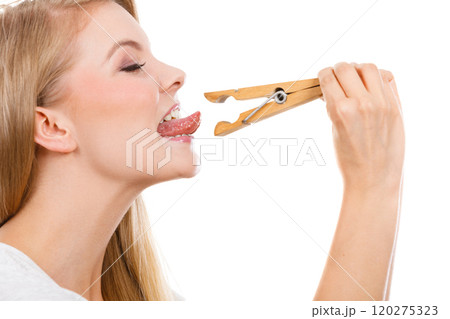 Blonde woman having tongue in clothespin 120275323