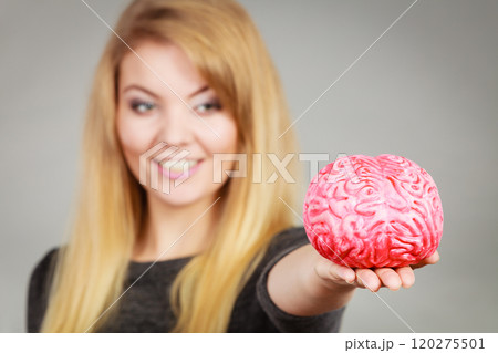 Woman holding brain having idea Woman holding brain having idea 120275501