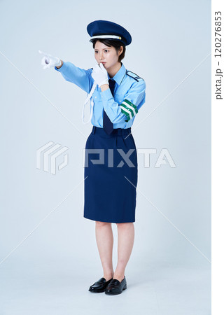 笛を鳴らしながら指さしをする女性警備員 笛を鳴らしながら指さしをする女性警備員 120276853