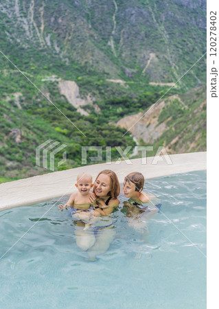 Mother with her toddler and teenage sons bathing in the hot springs of Grutas Tolantongo, Mexico. Family adventure, relaxation, and natural wellness concept 120278402