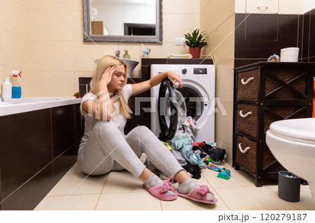 Frustrated Woman Struggles with Overwhelming Laundry Chaos in Her Bathroom Space Today Frustrated Woman Struggles with Overwhelming Laundry Chaos in Her Bathroom Space Today 120279187