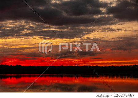 A Stunning Sunset Over Serene Lake With Beautiful Reflections in the Calm Waters A Stunning Sunset Over Serene Lake With Beautiful Reflections in the Calm Waters 120279467