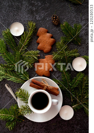 Santa's special delivery: Top-view shot of chic gift boxes, adorned with green bows, gold and green ornaments, star decorations, confetti on black backdrop, space for your festive wishes or promo 120280533