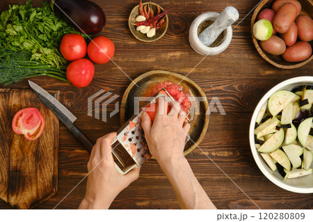 Preparing fresh ingredients for a vibrant dish on a wooden kitchen counter in a cozy home 120280809