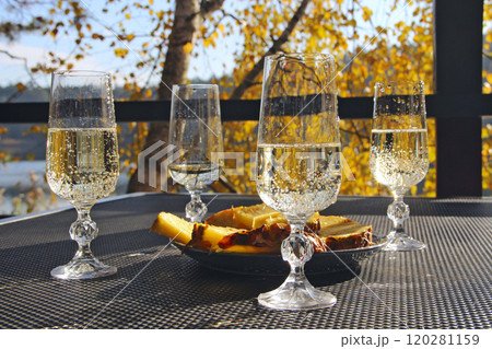 Bridal Shower. Four glasses of champagne with pineapples in nature 120281159
