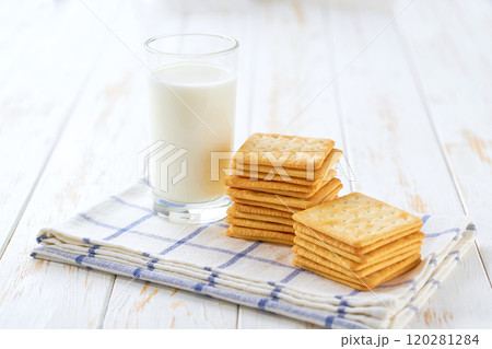 Wheat biscuits and milk on a white table, close up. Wheat biscuits and milk on a white table, close up. 120281284