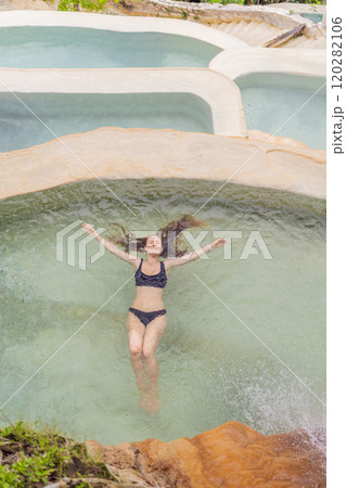 Female tourist at the hot springs of Grutas Tolantongo, Mexico. Adventure, relaxation, and natural wellness concept 120282106