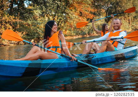 A group of happy young people are kayaking at th river. World Tourism Day concept 120282535