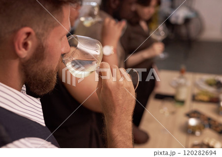 High angle shot of unrecognizable professional sommelier smelling chilled white wine to expertise body and notes High angle shot of unrecognizable professional sommelier smelling chilled white wine to expertise body and notes 120282694