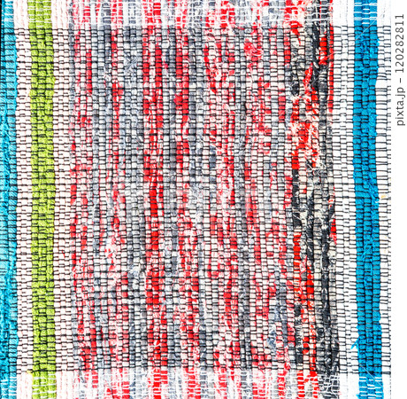 Old handmade homespun doormat from strips of cloth. Texture of a homemade rug 120282811